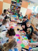 Dzieci z rodzicami wykonują kolorowe pisanki